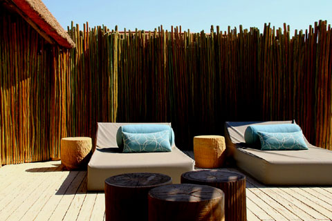 A rooftop bed made up under the star filled Namibian sky.