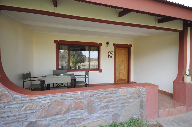 Outside of one of the guest rooms at Namib Desert Lodge showing the veranda sitting area.